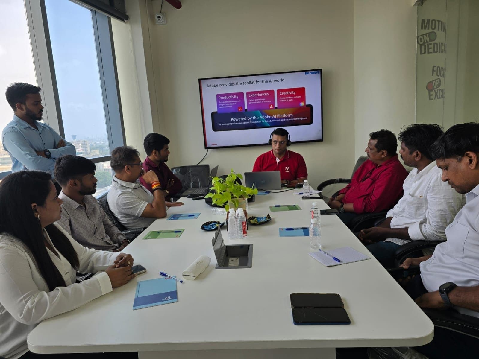 Wider view of Adobe AI Platform deep-dive session at Algoritham — conference table with team