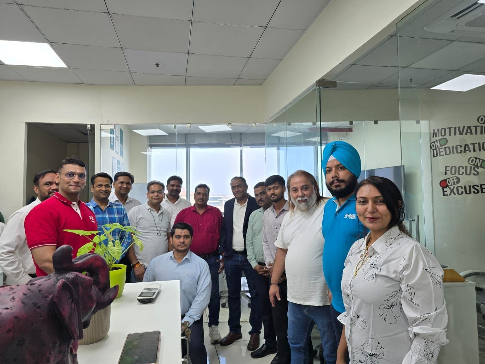 Algoritham team group photo at Adobe Immersion 2026 with 'Motivation On / Dedication On' wall